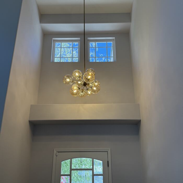 Two-story entry with a modern globe chandelier