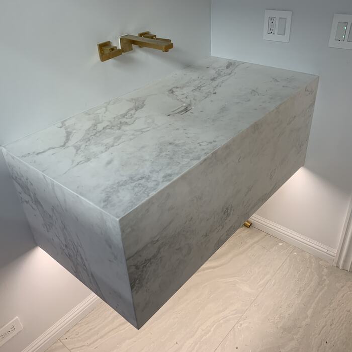Floating marble vanity with LED lighting underneath